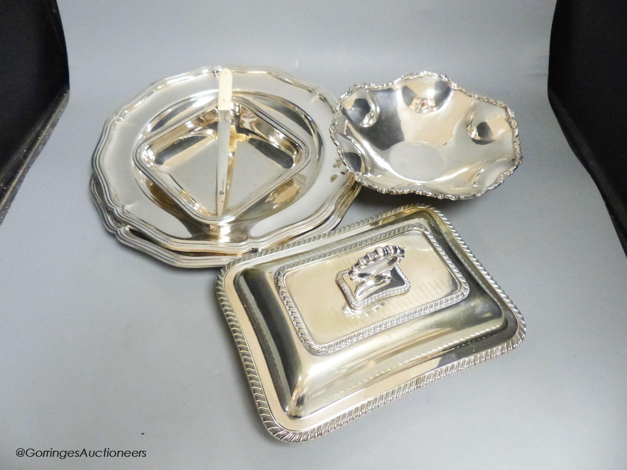 A pair of plated dinner plates, an entree dish and three other items